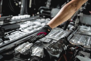 Tunning service worker install soundproofing material inside car interior