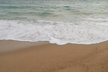 Sandy beach with small waves background