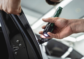 Replacing spare parts on a disassembled car in a car service garage