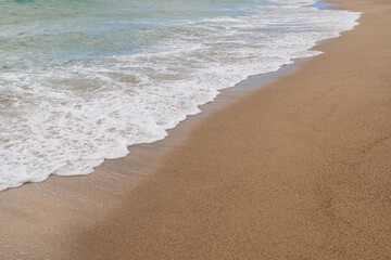 Sandy beach with small waves background