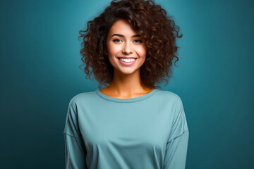 Woman with smile on her face and blue background.