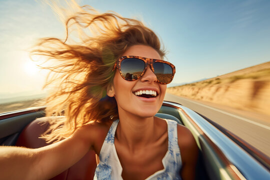 Dynamic portrait of a young beautiful woman with windswept hair driving a retro car - convertible, motion blur, retro style, selective focus, shallow depth of field