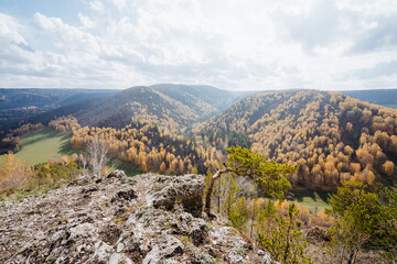 Fototapeta na wymiar Autumn landscape in the mountains, beautiful sunny day on the top of the mountain, golden crown of trees, hills covered with forest.