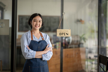 Startup business owner standing in an apron. SME entrepreneur invite and present with pride of her coffee shop business.
