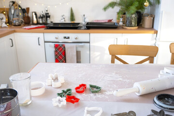 Layout of cookie cutters close-up cut out cookies from the dough with molds on a Christmas theme in the form of a snowman, a Christmas tree, stars in the kitchen