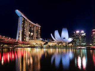 SINGAPORE - 2022 July : Night view at Marina Bay Sands Resort complex in Singapore. Luxury hotel and most expensive in world standalone casino property is main tourist attraction at  - 677063031