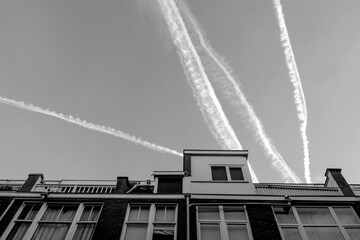 black white sky smog trace roof top plane house flight pollution Netherland