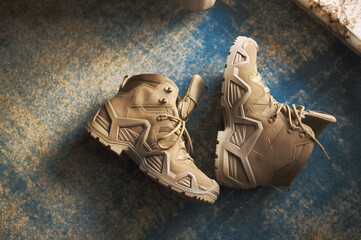 a pair of hiking or tactical boots abandoned on the carpet