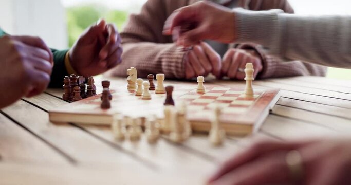 Hands, chess and game for strategy in closeup of board, challenge or tournament for outside, park or garden. Elderly people, together and fun with activity for thinking, problem solving and planning