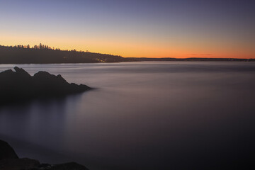 Fototapeta na wymiar sunrise over calm water - Lysaker