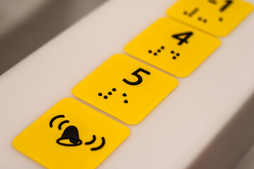 Yellow convex stickers with dots for blind people. A landmark for a blind person.
