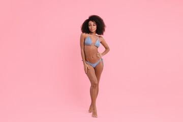 Fototapeta na wymiar Beautiful woman in stylish bikini on pink background
