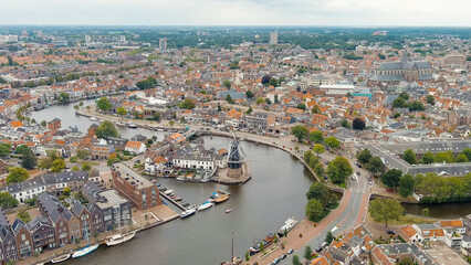 Haarlem, Netherlands. Windmill De Adriaan (1779). Windmill from the 18th century. Panoramic view of Haarlem city center. Cloudy weather during the day. Summer, Aerial View - obrazy, fototapety, plakaty