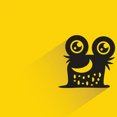 funny monster with shadow on yellow background