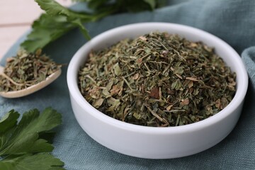 Fototapeta na wymiar Dried aromatic parsley and fresh leaves on table, closeup