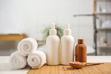 Composition with spa products on white table in bathroom