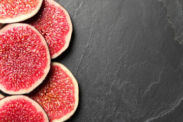 Pieces of fresh ripe figs on grey textured table, flat lay. Space for text