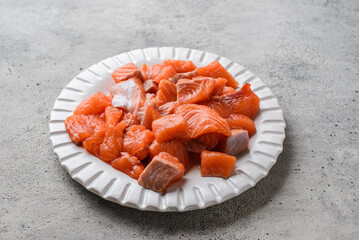 sliced pieces of raw salmon on a gray background
