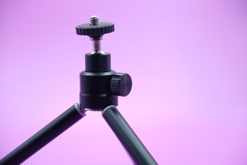 mini tripod for phone isolated on purple background