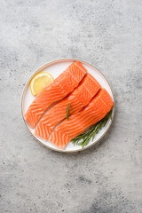 raw salmon on a gray background in a plate