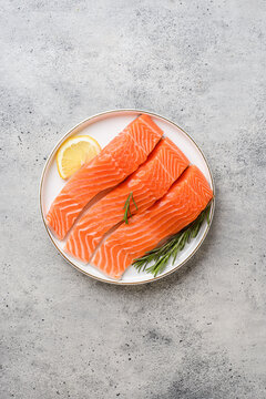 raw salmon on a gray background in a plate
