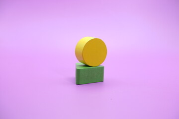 Set of colorful wooden shape toy (triangle and round) on Purple background