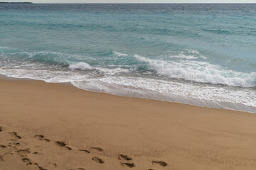 Sand beach of South France during spring with sea waves