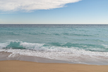 Fototapeta na wymiar Empty sand beach on Mediterranean sea with horizon line vacation background