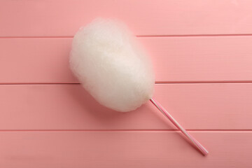 One sweet cotton candy on pink wooden table, top view