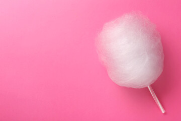 One sweet cotton candy on pink background, top view. Space for text