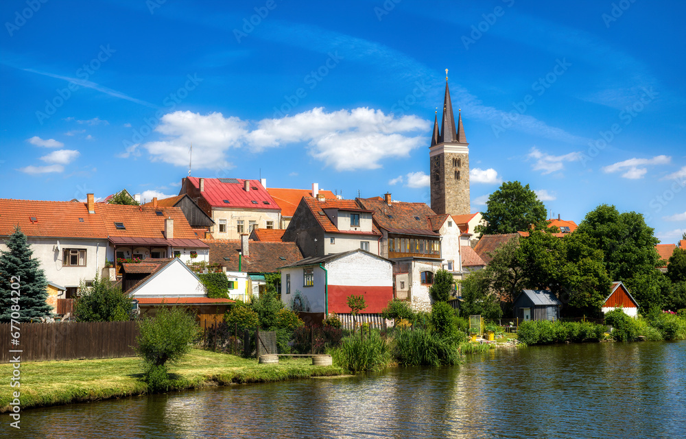 Wall mural houses in beautiful telc by the lake ulicky rybnik in the czech republic, with the tower of the chur