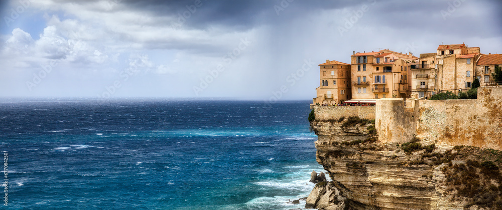 Wall mural the dramatic cliff with the old city of bonifacio on the southern tip of corsica, france