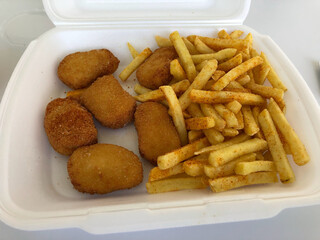 chicken nuggets with fries in take away packaging