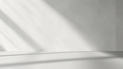 Minimal abstract light gray background for product presentation. Shadow and light from windows on plaster wall.