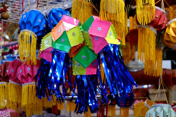 Fototapeta premium Hanging Diwali Lamp (Kandil) - Diwali Festival Background, Colourful lanterns made by paper eco friendly material akashkandil hang shop sell celebrating diwali festival in Pune, Maharashtra, India.