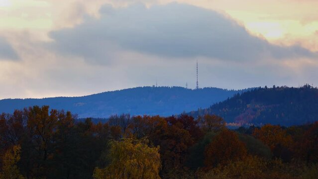 Hill Klet in Blansky les with autumn forest. Cloud time lapse when rain storm coming, Czech landscape