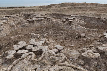 Dirt-covered salt mounds along Israel's Dead Sea coast