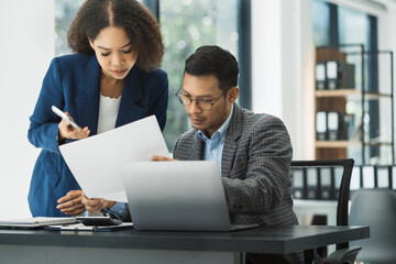 Stressed business team using a tablet to and  analysis graph company financial.