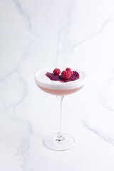 Alcoholic berry cocktail with raspberries 