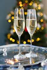 Glasses with champagne near Christmas tree
