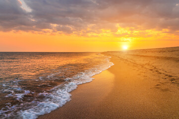 Fototapeta na wymiar Closeup sea sand beach. Panoramic beach landscape. Inspire tropical beach seascape horizon. Orange and golden sunset sky calmness tranquil relaxing sunlight summer mood