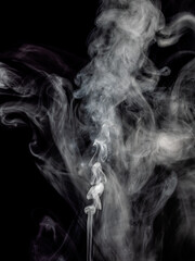 White smoke stream rises against a black background