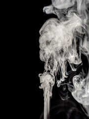 White smoke jet rises isolated on a black background