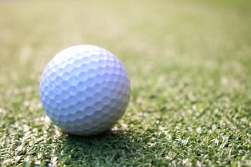 Golf ball placed on artificial grass.