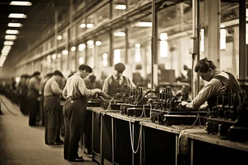 Fotobehang A black and white photo with sepia tones captures a 1920s industrial assembly line, showing a diverse group of men and women focused on their tasks amidst vintage machinery, evoking an era of early  © Kristian