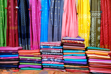Fancy Indian sarees, Neatly stacked colorful silk saris in racks in a textile shop. Incredible...