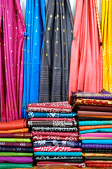 Fancy Indian sarees, Neatly stacked colorful silk saris in racks in a textile shop. Incredible...