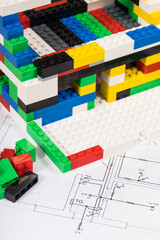 Housing plan with electric installation, house under construction made of toy blocks. Subject of...