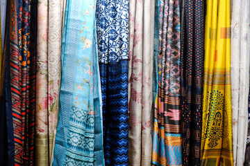 Fancy Indian sarees, Neatly stacked colorful silk saris in racks in a textile shop. Incredible India.
