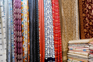 Fancy Indian sarees, Neatly stacked colorful silk saris in racks in a textile shop. Incredible...